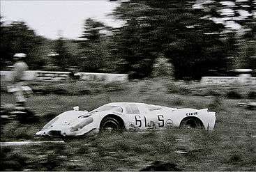 A black and white picture of a racing sports car.