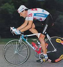 A man on a bike in a cycling jersey.