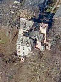 An ornate house on a hillside, seen from the air