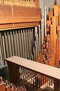 view of the chimes and several of the ranks of wooden and metal pipes inside one of the upper swell box inside the organ.