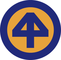 A yellow circular emblem with a blue "4" overlaid in normal and reverse, with a blue border