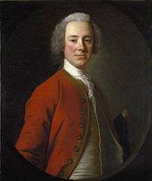 Lord Loudoun in a half-length portrait.  Painted when he was about 45, he faces the painter, wearing a red coat over a white vest and a white shirt with lace on the front.  His body is turned three quarters, so only his right arm is partially visible.  He appears to be wearing a powdered wig.
