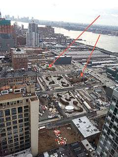 An aerial view of a construction site for the extension, with buildings surrounding it.