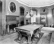 Billiard room with pool table, fireplace, and a hunting trophy