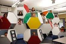  Brightly colored stacked truncated octahedrons with children's faces in the openings