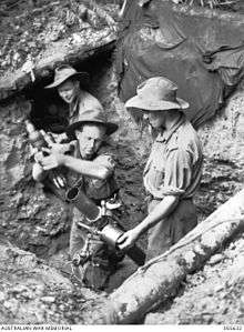 Soldiers loading a 3-inch mortar