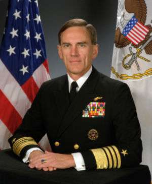 Man sitting in US Navy admiral's dress uniform