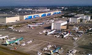 Boeing's factory in Everett, Washington in 2011. The planes are on tarmac outside warehouse-like buildings