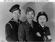 From left to right, a Sailor, a Soldier, and a navy officer take a group photograph.
