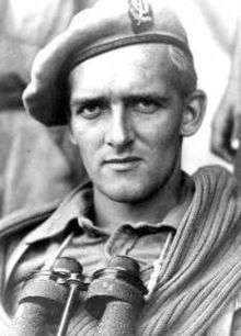 picture of soldier wearing beret and binoculars slung around neck