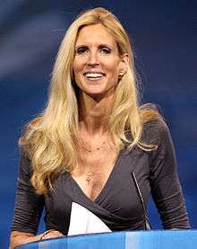 Ann Coulter smiling, with a blue wallpaper behind her.