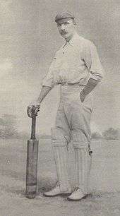 A cricketer holding a bat