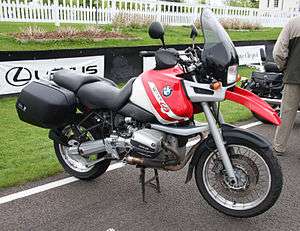 Red and white BMW R1100GS motorcycle with panniers