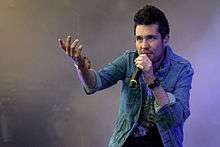 Lead vocalist Dan Smith holding a microphone