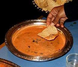 A bean dip served with tortilla chips