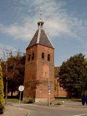 Red brick tower with a grey tile roof