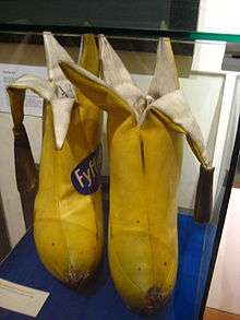 Two yellow bananas tailor-made in cloth with the tops peeled and the cloth skin hanging down.