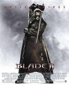 Blade ,standing in front the viewer ,wearing his traditional black special suit and coat, with his sunglasses on his eyes, holds his sword ,and has dark white-purple cloud background around him with the face of an evil vampire, underneath the film's name, credits ,billing and below; Wesley Snipes' name.