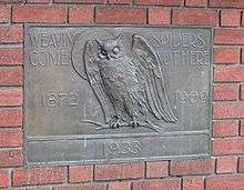 Plaque showing an owl, the moon, and text