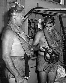 This is a photo of Commander (Medical Corps) George F. Bond and Chief Engineman Cyril Tuckfield after safely completing a 302-foot buoyant ascent in 52 SECONDS from the forward escape trunk of the USS Archerfish bottomed at 322 feet