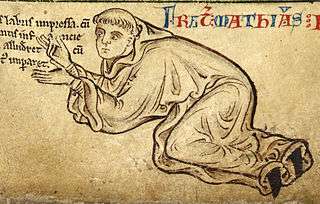 A pen and ink drawing from a medieval manuscript shows the monk kneel and bending forward beneath a line of text