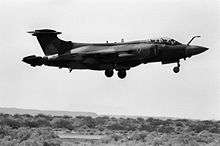 Black and white photograph of a Buccaneer aeroplane flying low.