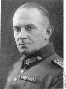 A man with short hair combed back wearing a military uniform.