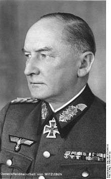 A man wearing a military uniform and neck order in the shape of a cross.