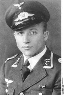 A man wearing a peaked cap and military uniform.