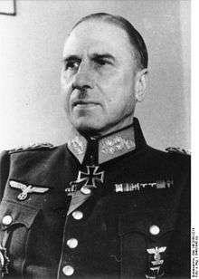A man wearing a military uniform, various military decorations including an Iron Cross displayed at the front of his uniform collar.