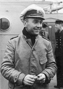 A smiling Prien is seen on deck, wearing his navy uniform.