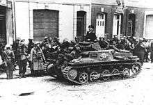 Black and white photo of soldiers with a small tank