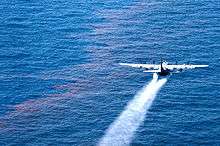 Plane spraying dispersants over an oil spill