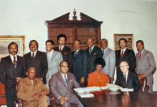 Rangel and twelve other African-American members of Congress posed around a table
