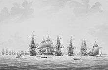 Print of Five sailing ships, four seen stern on, and the fifth from the side. A town and coastline in the background, with a line of distant ships in front of it.