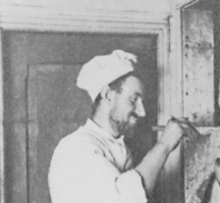 Black and white photograph of a bearded man with a chef's hat