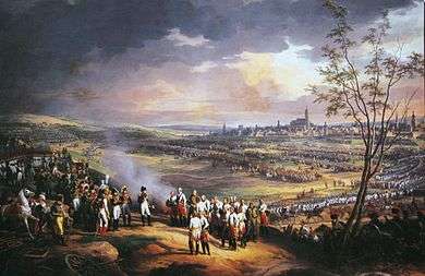 Colored painting depicting Napoleon receiving the surrender of the Austrian generals, with the opposing armies and the city of Ulm in the background.
