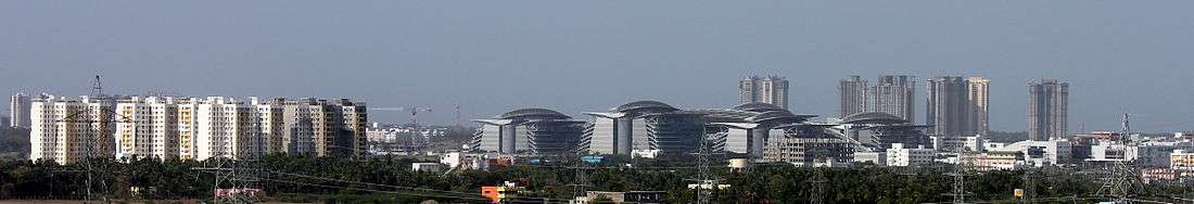 Panorama of TCS complex in Siruseri IT Park with housing projects nearby