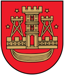 A coat of arms depicting a golden castle with three turrets surrounded with four golden stars all on a red background