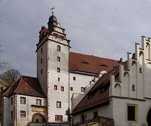 a whitewashed building with a red tiled roof, part of Colditz Castle