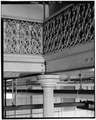 Detail view of column capital, floor joists, and decorative cast-iron railing; looking SSW from stairs to second floor, E wing. (Ceronie) - Rock Island Arsenal, Building No. HAER ILL,81-ROCIL,3-66-15.tif