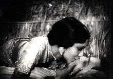 Devika Rani is seen sharing a full-mouth kiss with Himanshu Rai, with the former lying on the top.