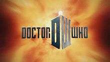 In front of a fiery background, steely gray block letters spell out "DOCTOR WHO". In between the two words is a large D and W which are angeled together to form a box; atop of the structure is a bright lamp light.