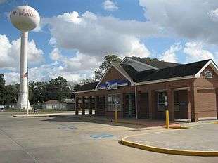 Photo shows a brick US post office building with a watertower on the left labeled "East Bernard".