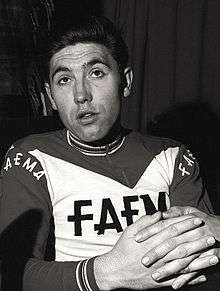 A cyclist wearing a jersey that reads "Faema."