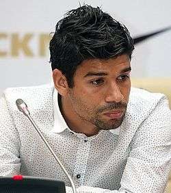 A colour photograph of Eduardo, at a press conference.