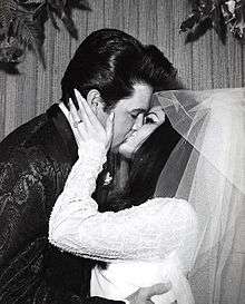 Photo of Elvis Presley kissing his new bride Priscilla
