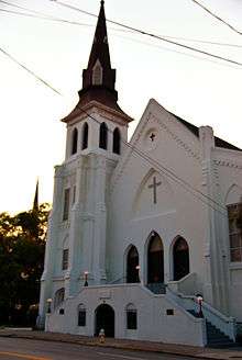 A white-painted church at sunset.