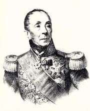Black and white print of a balding man with heavy-lidded eyes. He wears an elaborate military uniform with high collar, sash, and epaulettes