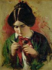 young woman holding a knitting needle, intently looking at a piece of cloth in her hands